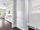 Entryway featuring a built-in bench, coat hooks, a nearby window, and an adjoining kitchen at 2222 Haventree Ct, Lawrenceville, GA 30043