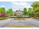 Beautiful gated entrance to a community featuring brick walls, black iron gates, and professional landscaping at 2222 Haventree Ct, Lawrenceville, GA 30043
