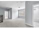 Hallway features neutral walls, plush carpet, and natural light from a window at 2222 Haventree Ct, Lawrenceville, GA 30043
