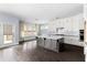 Well-lit kitchen features a large island, stainless appliances, and access to the backyard at 2222 Haventree Ct, Lawrenceville, GA 30043