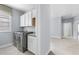 The laundry room features modern appliances, storage cabinets and a sink at 2222 Haventree Ct, Lawrenceville, GA 30043