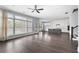 Spacious living room with hardwood floors, large windows, and an open floor plan leading to the kitchen at 2222 Haventree Ct, Lawrenceville, GA 30043