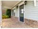 Covered front porch showcases brick accents and a black front door at 2222 Haventree Ct, Lawrenceville, GA 30043