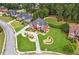 Aerial view showcasing a beautiful home with manicured landscaping in a tree-filled neighborhood at 3364 Kylee Dawn Cir, Lawrenceville, GA 30045