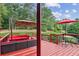 Outdoor deck featuring ample seating, lush greenery, and a well-maintained lawn at 3364 Kylee Dawn Cir, Lawrenceville, GA 30045