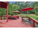 Outdoor deck featuring ample seating, lush greenery, and a well-maintained lawn at 3364 Kylee Dawn Cir, Lawrenceville, GA 30045