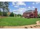Spacious backyard featuring a well-maintained lawn with patio and trees at 3364 Kylee Dawn Cir, Lawrenceville, GA 30045