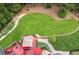 Aerial view of a backyard deck with outdoor seating, a well-manicured lawn, and lush landscaping at 3364 Kylee Dawn Cir, Lawrenceville, GA 30045