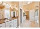 Luxurious bathroom with granite countertops, tiled floors, double sinks, decorative mirrors, and a separate shower and tub at 3364 Kylee Dawn Cir, Lawrenceville, GA 30045