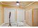 Bedroom featuring tiled floor, multiple closets, ceiling fan, and folding privacy screen at 3364 Kylee Dawn Cir, Lawrenceville, GA 30045
