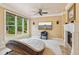 Bedroom featuring a unique circular daybed, fireplace, and large window with a view at 3364 Kylee Dawn Cir, Lawrenceville, GA 30045