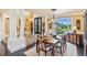 Elegant dining room with hardwood floors, a chandelier, and large window overlooking lush backyard at 3364 Kylee Dawn Cir, Lawrenceville, GA 30045