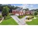 Spacious two-story red brick home with a long driveway and well-maintained landscaping at 3364 Kylee Dawn Cir, Lawrenceville, GA 30045