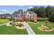 Stunning brick home boasting manicured landscaping, circular driveway, and mature trees at 3364 Kylee Dawn Cir, Lawrenceville, GA 30045