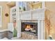 Elegant fireplace with detailed mantel, decorative vases, and built-in shelving in a bright living space at 3364 Kylee Dawn Cir, Lawrenceville, GA 30045