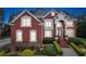 Beautiful red brick two-story home with manicured landscaping and a grand entrance at 3364 Kylee Dawn Cir, Lawrenceville, GA 30045