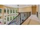 Spacious hallway with iron railing overlooking the living room and a wall of large windows at 3364 Kylee Dawn Cir, Lawrenceville, GA 30045