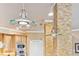 Close up on the unique pendant lights, stone pillar, and stainless steel appliances in this kitchen at 3364 Kylee Dawn Cir, Lawrenceville, GA 30045