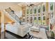 Bright and airy living room with a wall of windows, high ceilings, fireplace, and plush white sofas at 3364 Kylee Dawn Cir, Lawrenceville, GA 30045