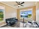 Cozy living room with hardwood floors, ceiling fan, and ample natural light from large windows at 3364 Kylee Dawn Cir, Lawrenceville, GA 30045