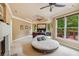 Main bedroom with tray ceiling, fireplace, sitting area, and access to a private balcony at 3364 Kylee Dawn Cir, Lawrenceville, GA 30045