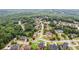 An aerial view showcases a neighborhood enveloped by mature trees, displaying natural beauty at 3364 Kylee Dawn Cir, Lawrenceville, GA 30045