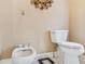 This half bathroom offers a toilet, bidet, and decorative mirror at 3364 Kylee Dawn Cir, Lawrenceville, GA 30045