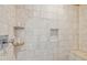 The bathroom offers a detailed tiled shower with a built-in seat and convenient inset shelving at 3364 Kylee Dawn Cir, Lawrenceville, GA 30045