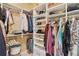 Organized walk-in closet with shelving and hanging rods for clothes and accessories at 3364 Kylee Dawn Cir, Lawrenceville, GA 30045