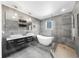 Modern bathroom features a soaking tub, dual vanities, and a frameless glass shower with stylish gray tiling at 4940 Sunrise Ln, Cumming, GA 30041