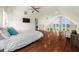 Bedroom with vaulted ceiling, hardwood floors, and staircase with stainless steel wire at 4940 Sunrise Ln, Cumming, GA 30041