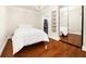 Comfortable bedroom featuring hardwood floors, mirrored closet, and modern light fixtures at 4940 Sunrise Ln, Cumming, GA 30041