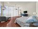 Bedroom with modern ceiling fan, hardwood floors, and large window with views at 4940 Sunrise Ln, Cumming, GA 30041