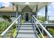 Inviting front porch with sleek railing and gray stairs, enhancing the curb appeal of this home at 4940 Sunrise Ln, Cumming, GA 30041