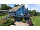 Beautiful home with a deck and under-house garage, enhanced by professionally landscaped surroundings at 4940 Sunrise Ln, Cumming, GA 30041