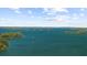 Image of a lake with wooded islands and clear blue skies and a few boats sailing by at 4940 Sunrise Ln, Cumming, GA 30041