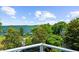 Expansive lake view from balcony, surrounded by lush greenery, offering a serene and picturesque setting at 4940 Sunrise Ln, Cumming, GA 30041