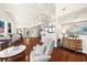 Open living room area with hardwood floors, high ceilings, and large windows offering lots of natural light at 4940 Sunrise Ln, Cumming, GA 30041