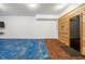 Spacious recreation room featuring a sauna, with light wood paneling, and a blue floor, perfect for relaxation at 4940 Sunrise Ln, Cumming, GA 30041