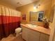 Cozy bathroom features a vanity with sink, framed mirror, and a shower with a colorful curtain at 1251 Branch, Tucker, GA 30084