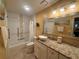 Bathroom with tub and shower, granite vanity, decorative mirror, and neutral color palatte at 1251 Branch, Tucker, GA 30084