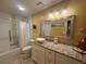Bathroom with tub and shower, granite vanity, decorative mirror, and neutral color palatte at 1251 Branch, Tucker, GA 30084