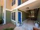 Charming condo entrance with a bright blue door, covered walkway, and potted plants at 1251 Branch, Tucker, GA 30084