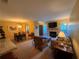 Open concept living and dining areas with hardwood floors, stone fireplace, comfortable seating, and natural light at 1251 Branch, Tucker, GA 30084