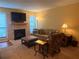 Warm living room with stone fireplace, large sofa, patterned chair, and soft natural lighting at 1251 Branch, Tucker, GA 30084