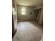 A basement with tile floors, a window, and an unfinished aesthetic at 1889 Browns Mill Se Rd, Atlanta, GA 30315
