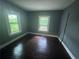 Bedroom featuring wood floors, two windows, and neutral walls at 1889 Browns Mill Se Rd, Atlanta, GA 30315