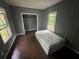 Bedroom boasting wood panel walls, wood floors and a large window at 1889 Browns Mill Se Rd, Atlanta, GA 30315