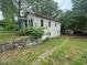 Side view of home with a detached garage and grassy area at 1889 Browns Mill Se Rd, Atlanta, GA 30315