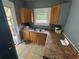 A kitchen with wood cabinets, laminate countertops, and a double sink at 1889 Browns Mill Se Rd, Atlanta, GA 30315